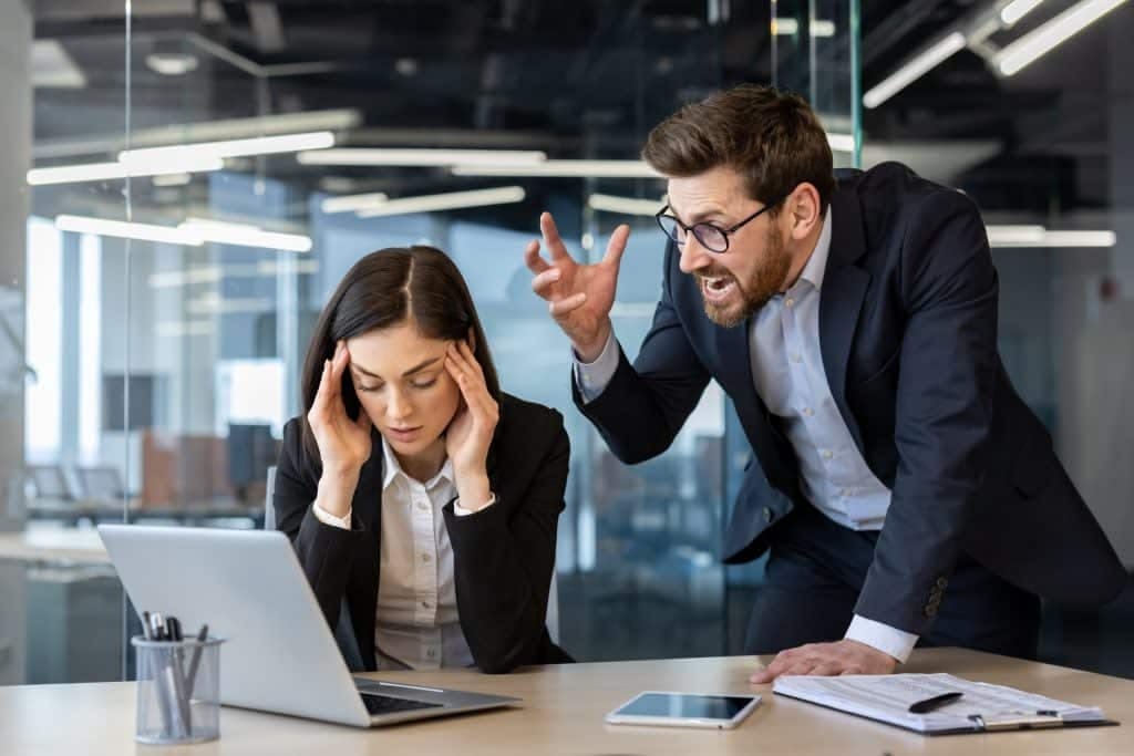 a boss yelling at a woman