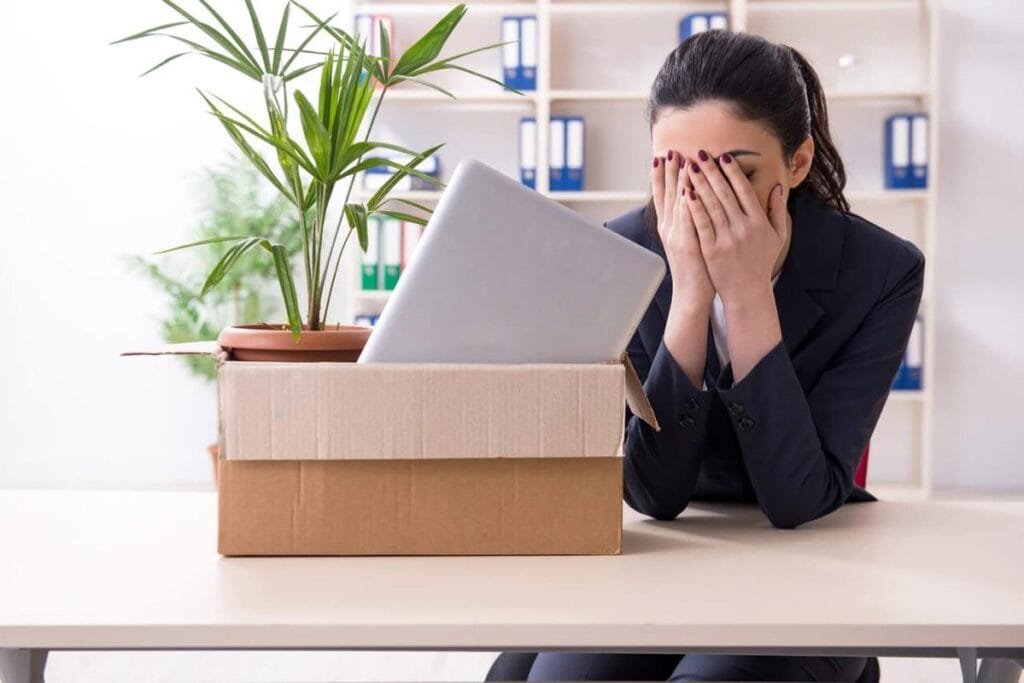 Unemployed worker looking at an approved state unemployment application online after being fired